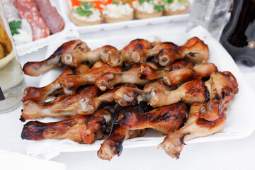 dish with baked chicken legs. They lie on a white plate and look delicious with a golden crust.