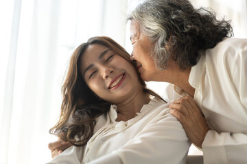 Fototapeta premium Portrait of enjoy happy love asian family senior mature mother and young daughter smiling play laughing and having fun together at home, care, elderly, insurance.happy family and Mother Day concept