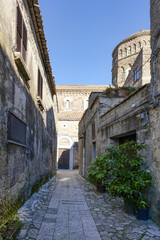 A narrow street between the houses of old Caserta, a medieval village in Italy.