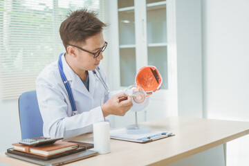 Male doctor specializing in eye diseases, providing consultations at a hospital, discussing eye...
