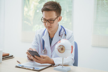 Male doctor specializing in eye diseases, providing consultations at a hospital, discussing eye...