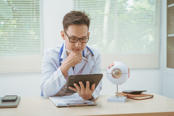 Male doctor specializing in eye diseases, providing consultations at a hospital, discussing eye...