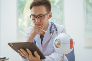 Male doctor specializing in eye diseases, providing consultations at a hospital, discussing eye...