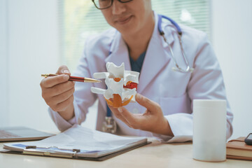 Male doctor treating bone diseases at a hospital, discussing scoliosis, herniated discs, osteoporosis, diagnosing bone density issues, and providing treatment plans for brittle bones, fractures