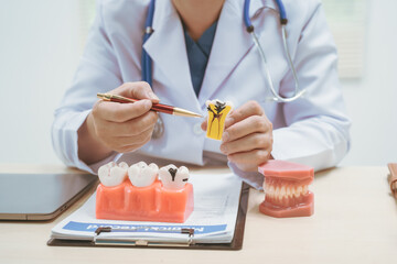 Male doctor treating dental diseases at a hospital, discussing tooth decay, crooked teeth broken...