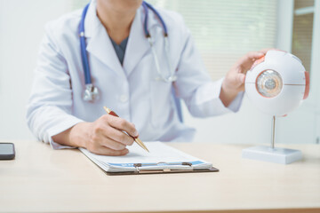Male doctor specializing in eye diseases, providing consultations at a hospital, discussing eye...
