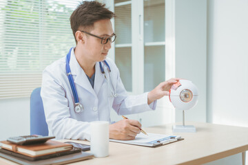 Male doctor specializing in eye diseases, providing consultations at a hospital, discussing eye...