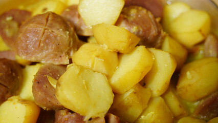 close-up of boiled meatballs and potatoes with steamy texture