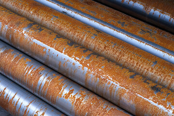Rusty metal pipes with weathered texture. The image evokes a sense of age and industrial decay. Idea of manufacturing environment.