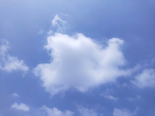 blue sky with mysterious bird shape visible in the cloud formation