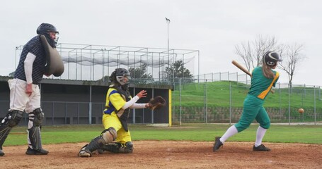 Multiracial female baseball players and male umpire, hitting the ball and running on a pitch - Powered by Adobe