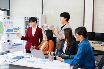 Fototapeta premium Group of diverse businesspeople using a laptop and tablet in office.