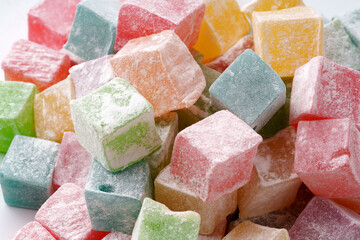 Colorful assortment of Turkish delight candies displayed on a white background