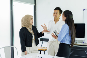 Happy excited Business team working and handshake on a laptop computer.