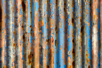Weathered Metallic Surface with Rust and Blue Paint Stripes
