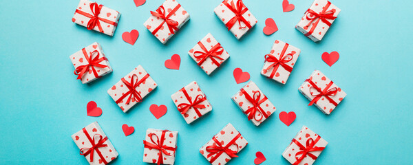 Valentine day composition Background: red gift box with bow and heart. Christmas present. View from above. Holday greeting card