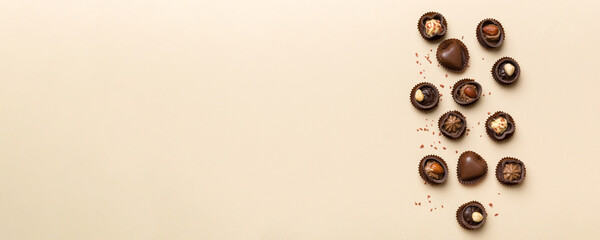 Different kinds of chocolates on colored table close-up. Top View and Flat Lay with copy space