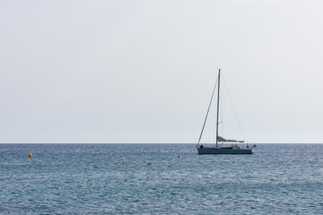 sailboat sailing on a calm sea on a sunny day