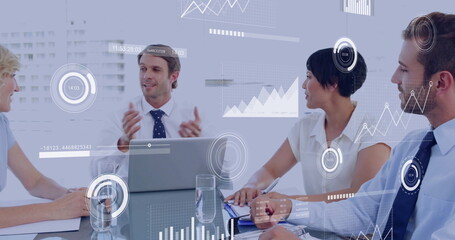 Image of financial data processing over diverse business people in meeting in office