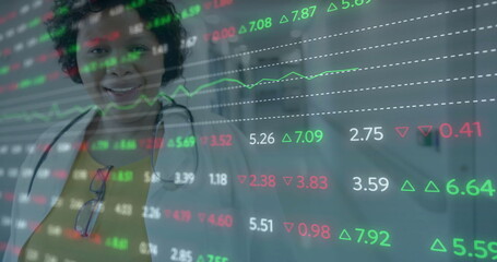 Stock market data image over smiling healthcare professional in hospital corridor