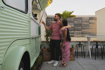 Couple ordering drinks at food truck