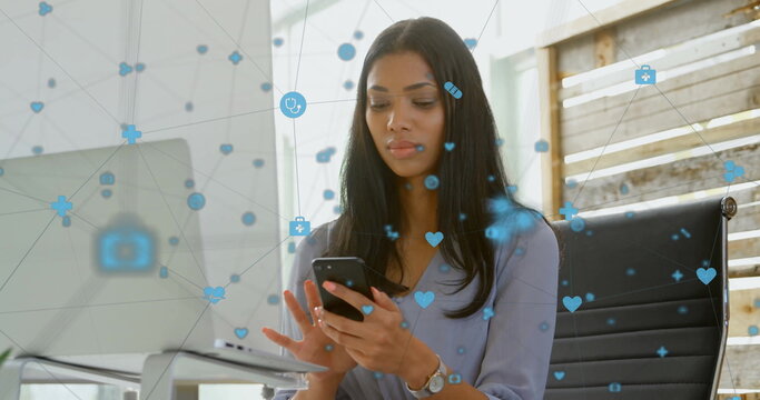 Image of network of connections with digital icons over biracial woman using smartphone