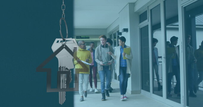 Image of silver house key and key fob over diverse businesspeople - Powered by Adobe