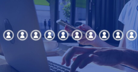 Image of network of people icons over caucasian businesswoman using smartphone and laptop