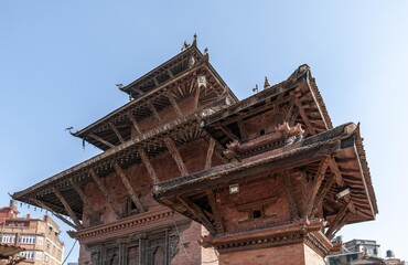Temples and palaces, stifling smog and the smell of incense, a living goddess, the roar of horns, a...