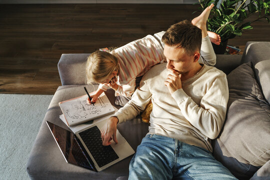 Father and daughter completing tasks at home