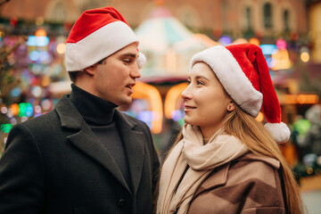 Couple wearing Santa hat spending leisure time with each other