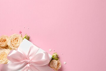 Beautiful composition with peony roses and gift box on color background