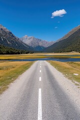 Fototapeta premium Scenic Road Journey Through Majestic Mountains and Serene Lake