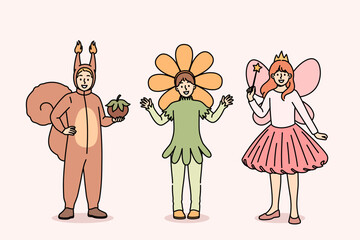 Little children in carnival costumes of squirrel or fairy and flower are ready to go to masquerade party at school. Boy and girls gathered for masquerade dedicated to end of studies in kindergarten © Dzianis Vasilyeu