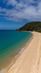 Scenic view of a pristine sandy beach with turquoise waters.