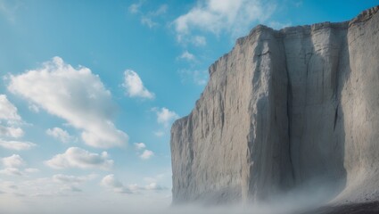 Majestic Rocky Cliff Surrounded by a Vibrant Blue Sky and Fluffy White Clouds Evoking a Sense of Natural Beauty and Tranquility in the Outdoors.