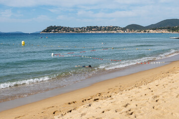 Morning view on crystal clear blue water of Plage du Debarquement white sandy beach near Cavalaire-sur-Mer and La Croix-Valmer, summer vacation on French Riviera, Var, France