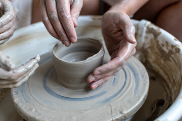 Making of mud pot on potters wheel during workshop in art ceramic atelier in Poland