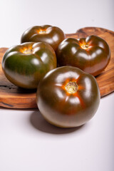 Fresh ripe sweet reddish brown and green kumato tomatoes close up