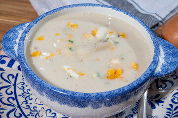 Spring season, homemade soup from raw white asparagus and cooked eggs, new harvest of Dutch, German white asparagus