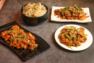 Variety of Chinese dishes including stir-fry, rice, chicken, shrimp served in a traditional setting, ideal for food blogs, restaurant menus, culinary magazines, or Asian cuisine advertisements.