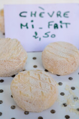 French goat cheeses fresh and crottin chavignol, made from unpasteurised goat milt, different taste on farmers market in Biarritz, France