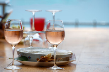 Summer time in Provence, two glasses of cold rose wine with blue sea view on background, French Riviera near Menton, south of France