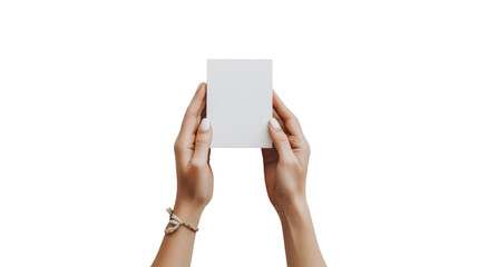 A pair of female hands delicately hold a blank white rectangular card against a black background providing a clean mockup for various applications.