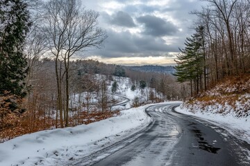 Obraz premium Winding snow-covered road through winter forest.