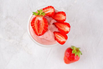 Whipped strawberry tofu and pudding dessert on a table. Vegan food. Lactose and sugar free. Top view.