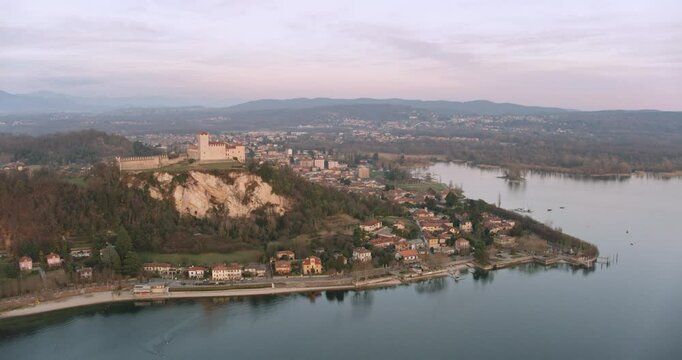 Aerial view of Rocca di Angera fortress on lake Maggiore at sunset, Lombardy, Italy