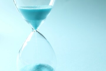 Modern hourglass on color background. Hourglass time concept for business deadline, urgency and...