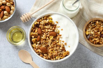 Delicious granola with yogurt on a gray background