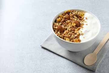 Delicious granola with yogurt on a gray background